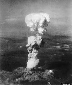 White fragmentred mushroom-like smoke cloud evolving from the ground.