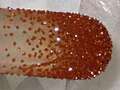 Image of deep red-orange, freshly vaccuum-sublimed ferrocene crystals on a cold-finger condenser.