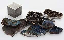 A rough fragment of lustrous silvery manganese metal