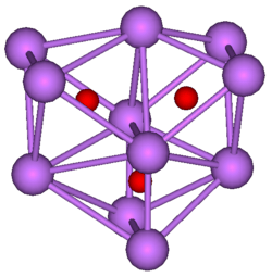 The stick and ball diagram shows three regular octahedra, which are connected to the next one by one surface and the last one shares one surface with the first. All three have one edge in common. All eleven vertices are purple spheres representing caesium, and at the center of each octahedron is a small red sphere representing oxygen.