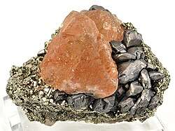 Pink fluorite perched between pyrite (left) and metallic galena (right)