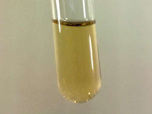 Small sample of pale yellow liquid fluorine condensed in liquid nitrogen