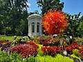 Henry Shaw's mausoleum at the Missouri Botanical Garden, with a glass art piece by Dale Chihuly in front of it as of 2023