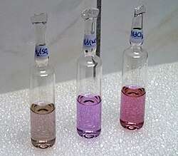 Neodymium compounds in fluorescent tube light—from left to right, the sulfate, nitrate, and chloride