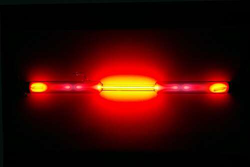 A glass tube with a red glow emanating from it