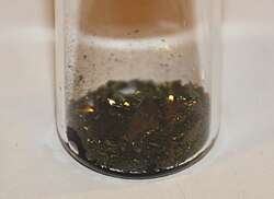 Black lumps in a glass beaker