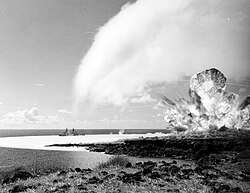 Detonation of the 500-ton TNT explosive charge as part of Operation Sailor Hat in 1965. The passing blast-wave left a white water surface behind and a white condensation cloud is visible overhead.