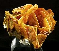 Cluster of translucent, butterscotch-colored wulfenite blades from the Glove Mine, Arizona, US