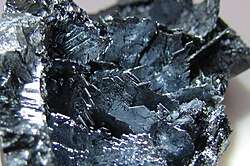 Shiny violet-black colored crystalline shards.