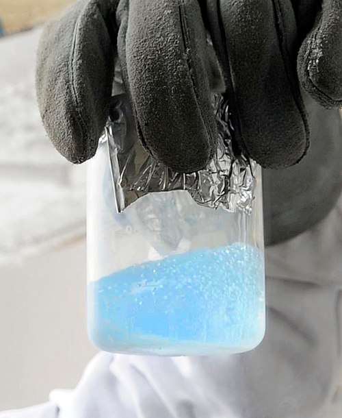 A pale blue liquid, with visible boiling