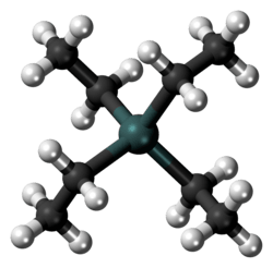 A gray-green sphere linked to four black spheres, each, in turn, linked also to three white ones