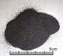 A small heap of uniform black grains smaller than 1mm in diameter