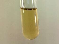 Small sample of pale yellow liquid Fluorine condensed in liquid Nitrogen